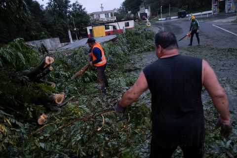 W niedzielę ludzie oczyszczają ścieżkę z powalonego drzewa w Yaoco w Portoryko.